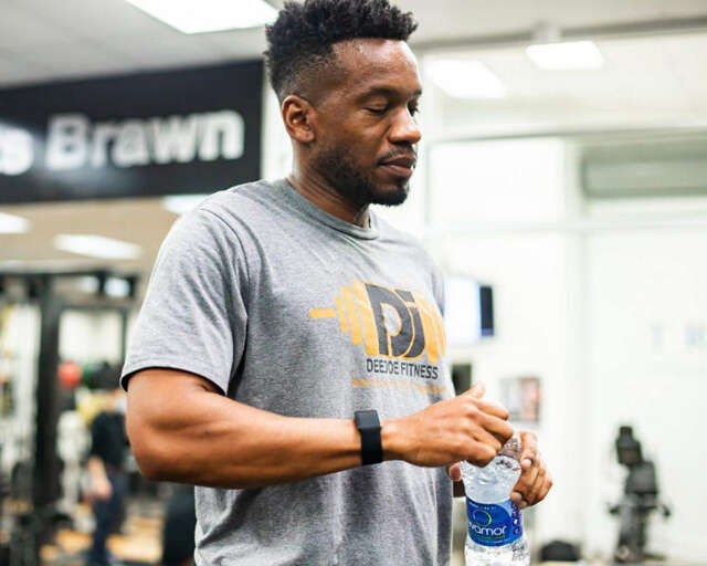 Derrick Joseph working out in gym with evamor bottle
