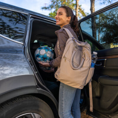 Soccer mom loading car with equipment